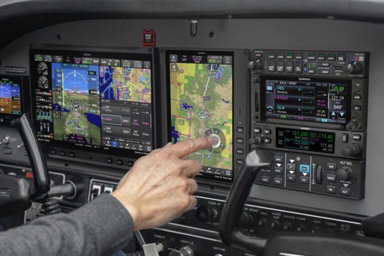 Pilot using the touchscreen map on a certified Garmin AXIS installation with autopilot and radio stack